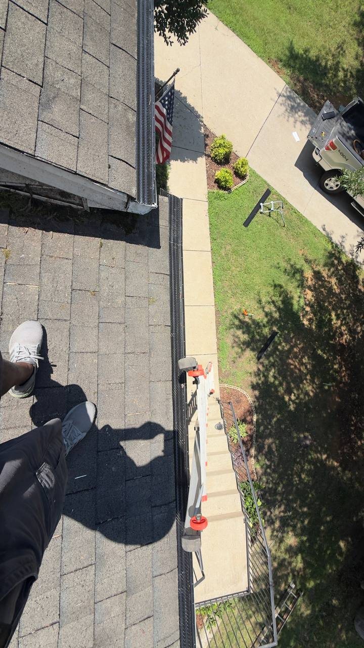 Installed gutter guards along an upper roofline